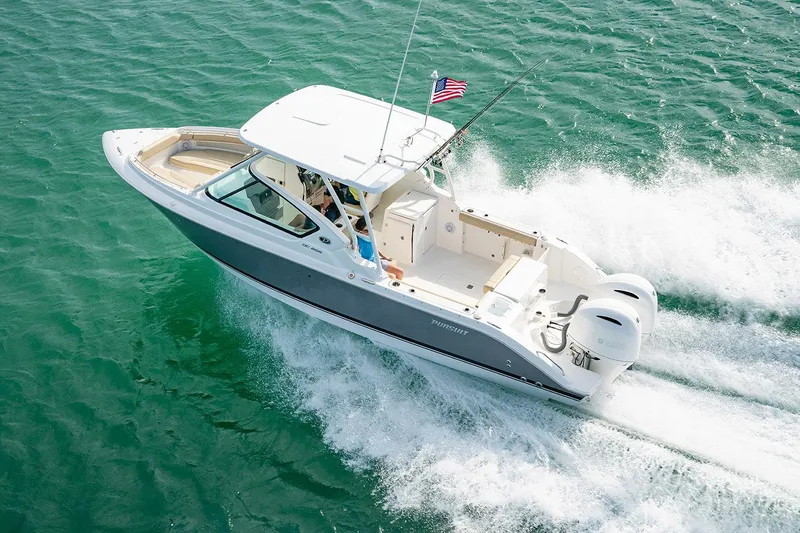 Slide: The Image of Manufacturer Provided Image: 2022 Pursuit DC 266 Dual Console boat cruising on clear blue water. - 38
