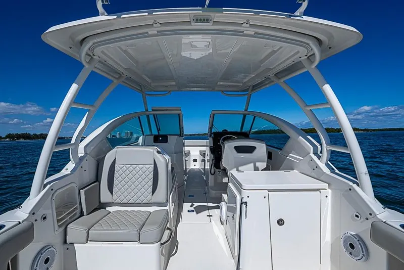 Slide: The Image of 2022 Pursuit DC 266 Dual Console boat interior with seating and ocean view. - 8