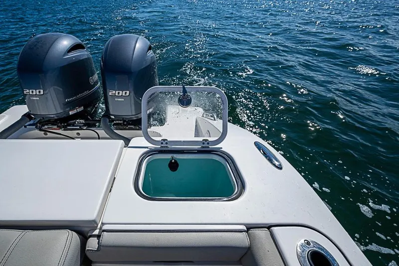 Slide: The Image of 2022 Pursuit DC 266 Dual Console boat with twin Yamaha 200 engines on open water. - 9
