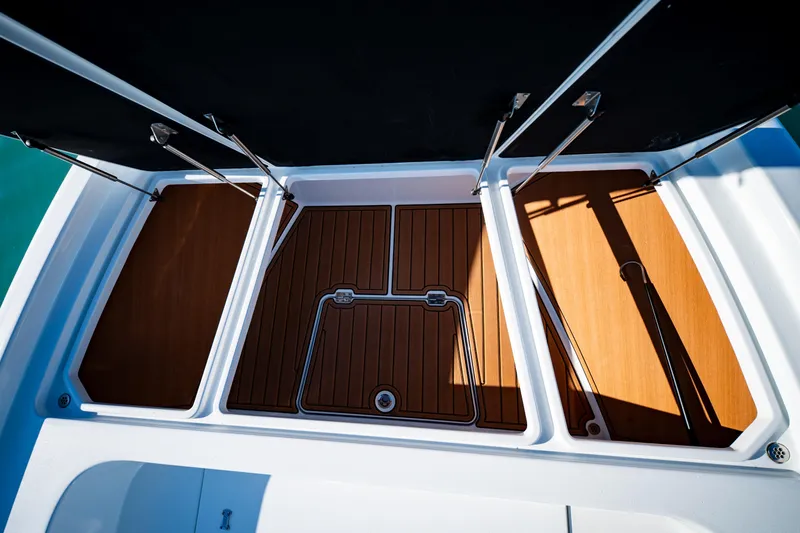 Slide: The Image of 2016 Barker Boatworks 26 Calibogue Bay deck with open storage compartments. - 11