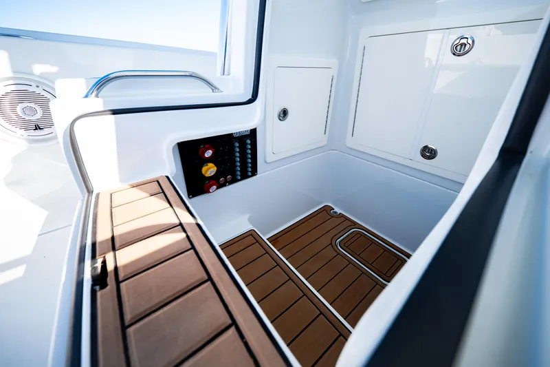 Slide: The Image of 2016 Barker Boatworks 26 Calibogue Bay interior with teak flooring and storage compartments. - 16