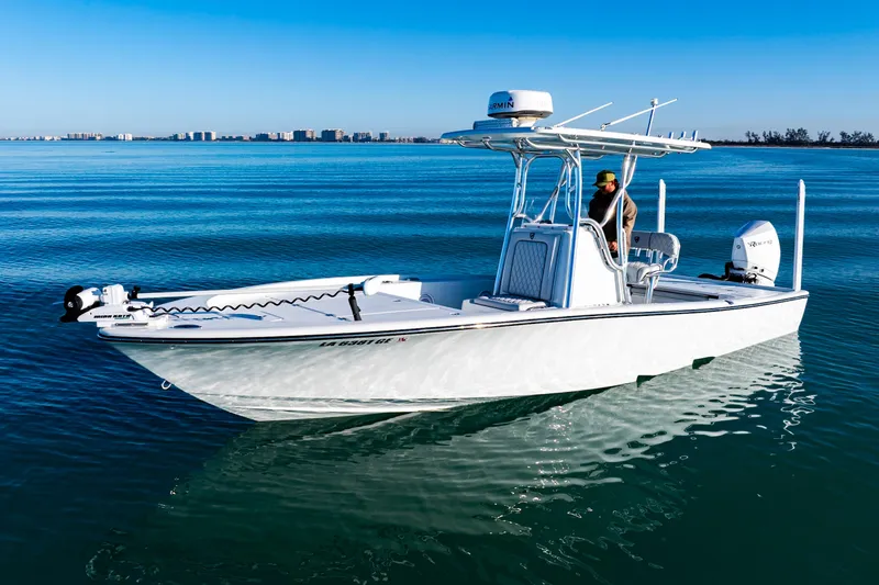 Slide: The Image of 2016 Barker Boatworks 26 Calibogue Bay on calm blue water, clear sky background. - 2
