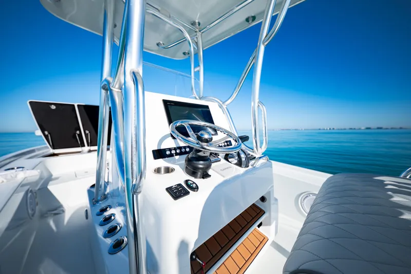 Slide: The Image of 2016 Barker Boatworks 26 Calibogue Bay helm with ocean view, featuring modern controls. - 20