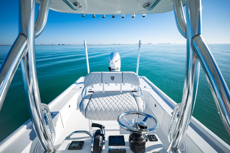 Slide: The Image of 2016 Barker Boatworks 26 Calibogue Bay on calm ocean waters, showcasing sleek design and controls. - 22