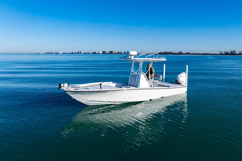 Slide: The Image of 2016 Barker Boatworks 26 Calibogue Bay on calm blue water under clear sky. - 1
