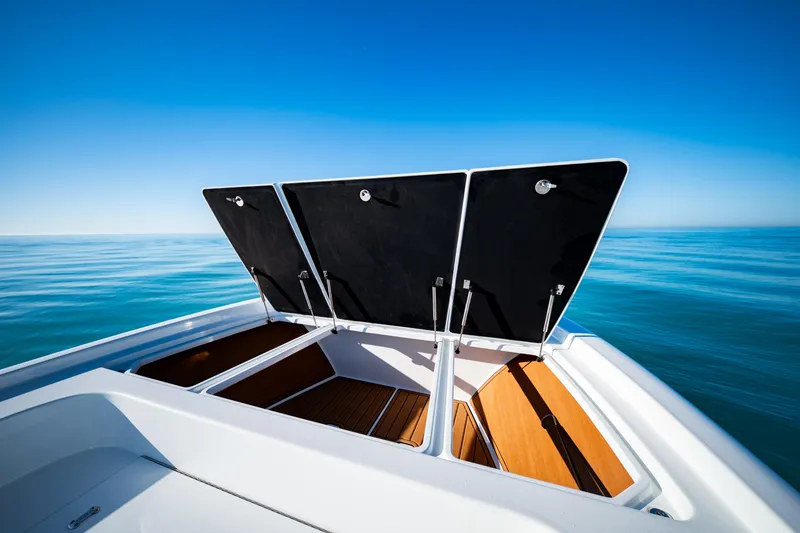 Slide: The Image of 2016 Barker Boatworks 26 Calibogue Bay with open storage compartments on calm sea. - 10