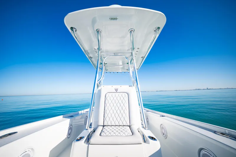 Slide: The Image of 2016 Barker Boatworks 26 Calibogue Bay on calm blue waters, featuring sleek design and seating. - 14