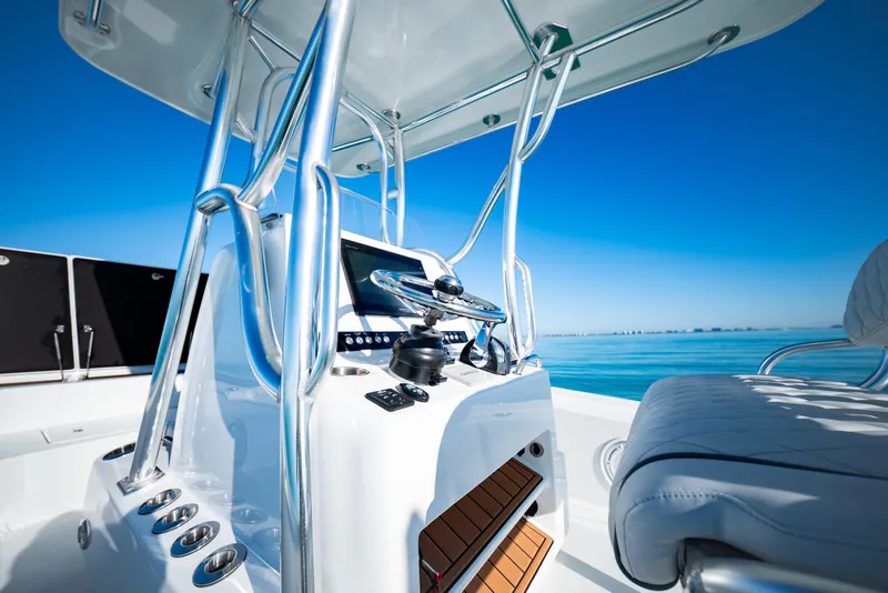 Slide: The Image of 2016 Barker Boatworks 26 Calibogue Bay helm with ocean view and sleek design. - 17