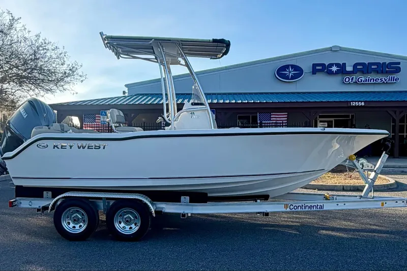 The Image of 2026 Key West 203 FS boat on trailer outside Polaris dealership. - 0