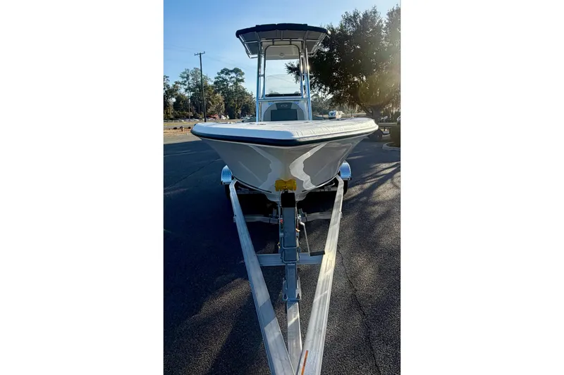 Slide: The Image of 2026 Key West 203 FS boat on trailer, parked outdoors, front view. - 2