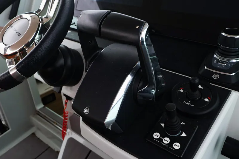Slide: The Image of Control panel of 2023 Saxdor 320 GTO boat with steering wheel and throttle. - 12