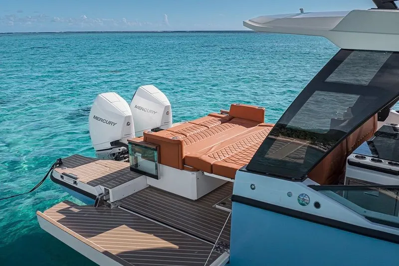 Slide: The Image of 2023 Saxdor 320 GTO luxury boat with Mercury engines on turquoise water. - 2