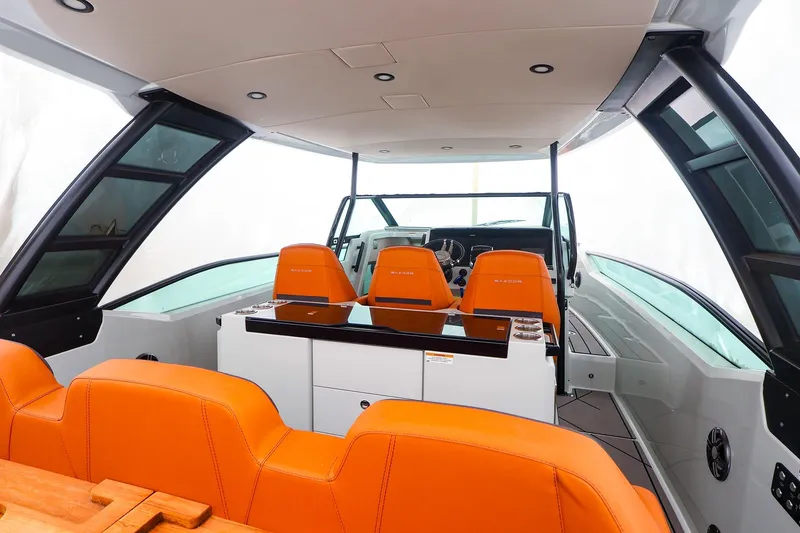 Slide: The Image of Interior of 2023 Saxdor 320 GTO boat with orange seating and modern design. - 6