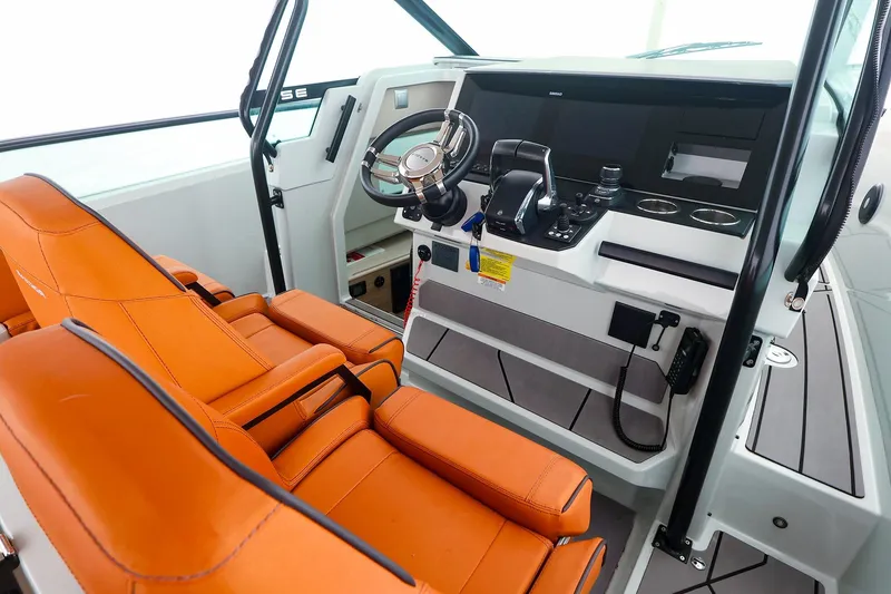 Slide: The Image of 2023 Saxdor 320 GTO helm with orange seats and modern controls. - 7