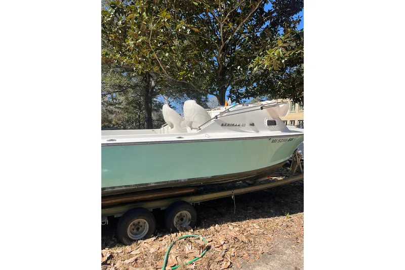 Slide: The Image of 1965 Bertram 20 Bahia Mar boat on trailer under trees. - 3