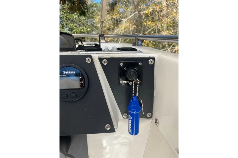 Slide: The Image of 1965 Bertram 20 Bahia Mar dashboard with Yamaha controls and keychain. - 4