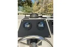 Slide: The Image of Dashboard of a 1965 Bertram 20 Bahia Mar boat with gauges and steering wheel. - 5