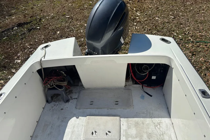 Slide: The Image of 1965 Bertram 20 Bahia Mar boat with outboard motor in a wooded area. - 9