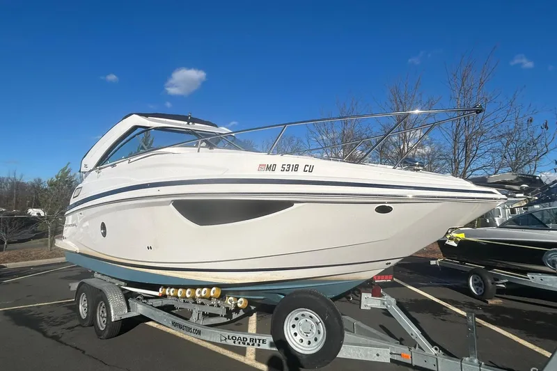 The Image of 2024 Regal 28 Express boat on trailer under clear blue sky. - 0