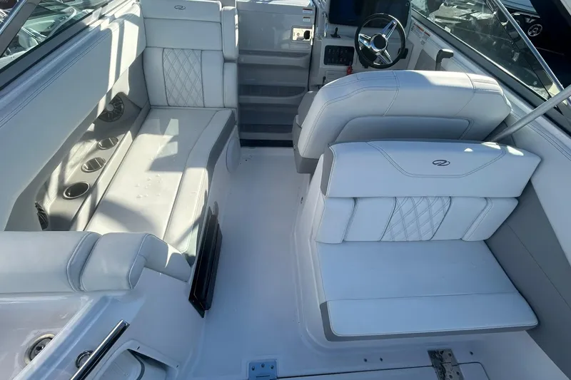 Slide: The Image of 2024 Regal 28 Express boat interior with white seating and modern dashboard. - 30