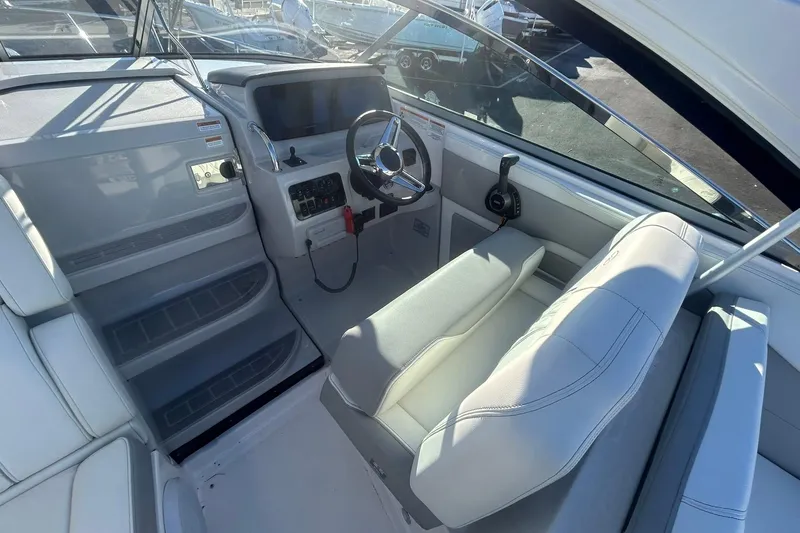 Slide: The Image of 2024 Regal 28 Express boat cockpit with modern steering and controls. - 33