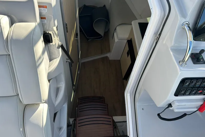 Slide: The Image of Interior view of 2024 Regal 28 Express boat, featuring seating and control panel. - 37