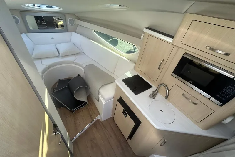 Slide: The Image of 2024 Regal 28 Express cabin interior with kitchenette, seating, and modern amenities. - 38