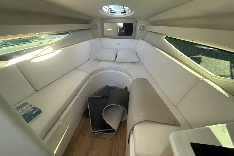 Slide: The Image of 2024 Regal 28 Express cabin interior with white seating and natural light. - 39