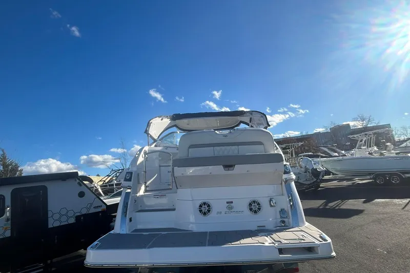 Slide: The Image of 2024 Regal 28 Express boat in a sunny outdoor setting, showcasing its sleek design. - 4