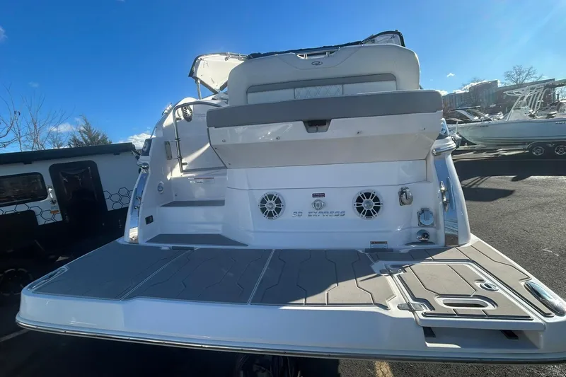 Slide: The Image of 2024 Regal 28 Express boat rear view with spacious deck and seating. - 7