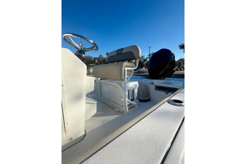 Slide: The Image of 2026 Key West 210 Bay Reef boat interior with steering wheel and seating. - 11