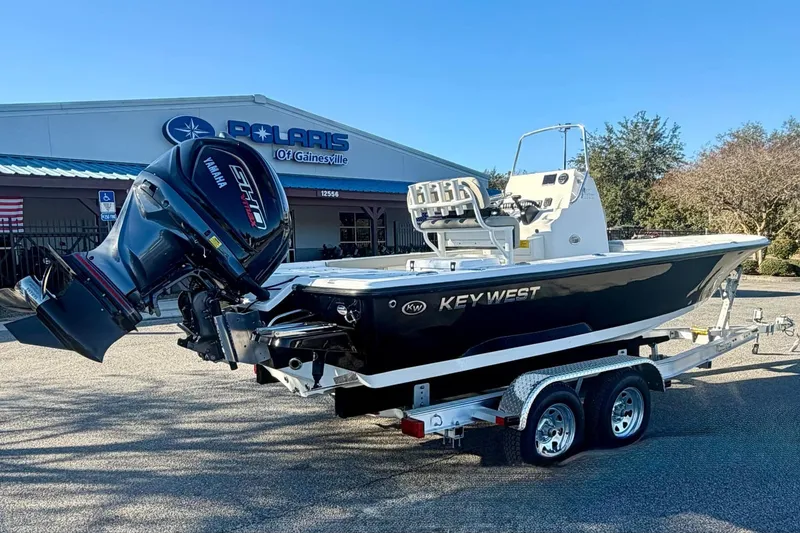 Slide: The Image of 2026 Key West 210 Bay Reef boat on trailer, parked outside dealership. - 5