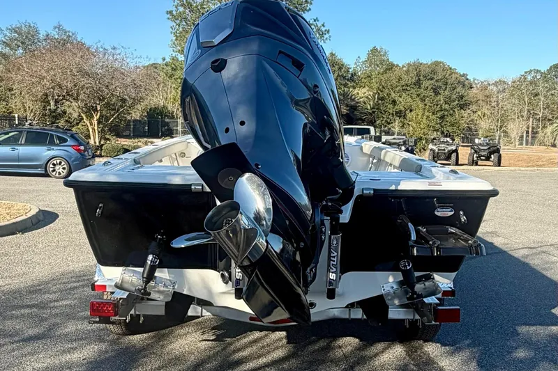 Slide: The Image of 2026 Key West 210 Bay Reef boat with powerful outboard motor in a parking area. - 6