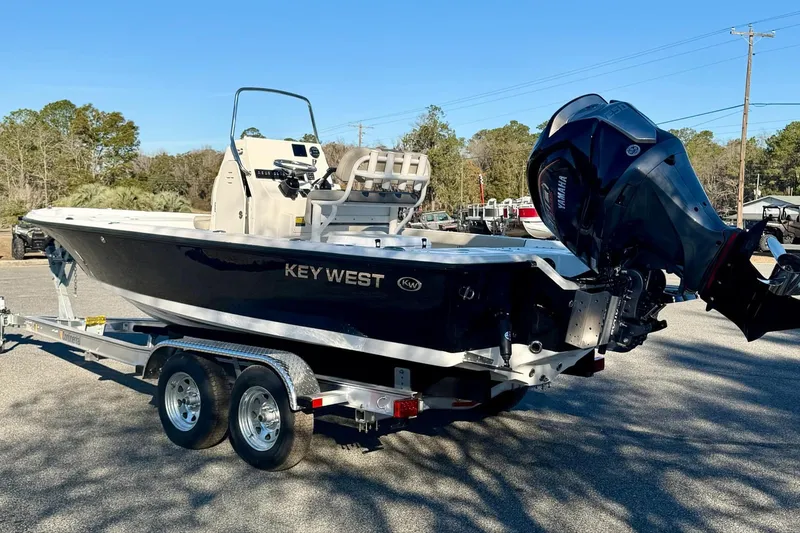 Slide: The Image of 2026 Key West 210 Bay Reef boat on trailer, featuring sleek design and powerful outboard motor. - 7