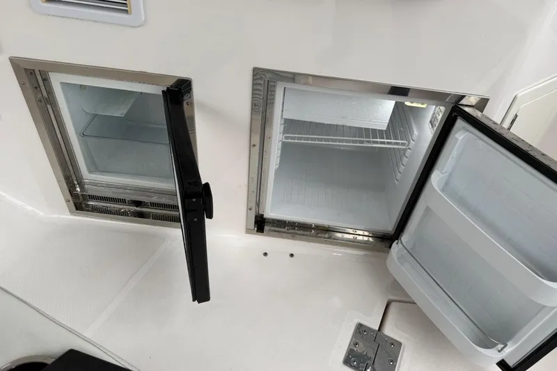 Slide: The Image of 2012 Regal 35 Sport Coupe boat interior with open mini fridge compartments. - 12