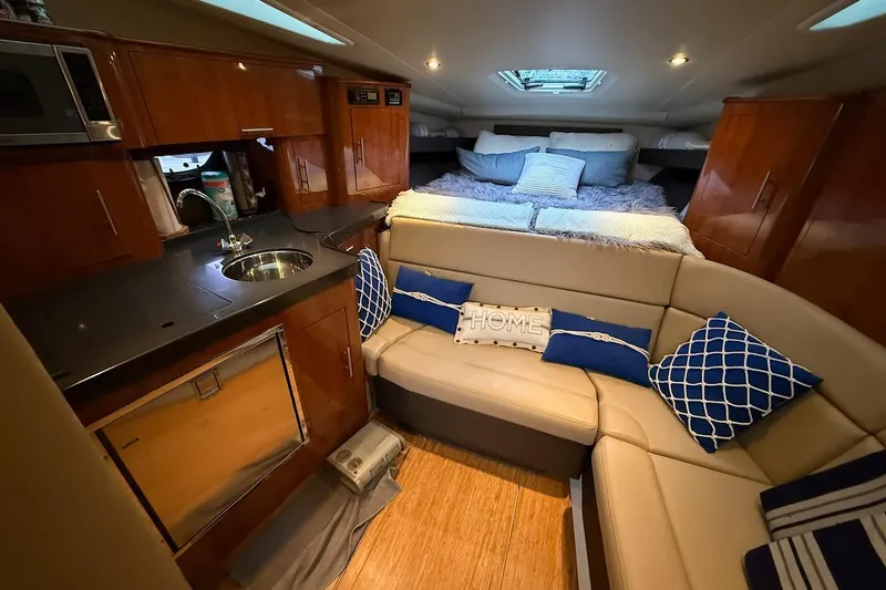 Slide: The Image of Luxurious interior of 2012 Regal 35 Sport Coupe with cozy seating and modern kitchenette. - 14