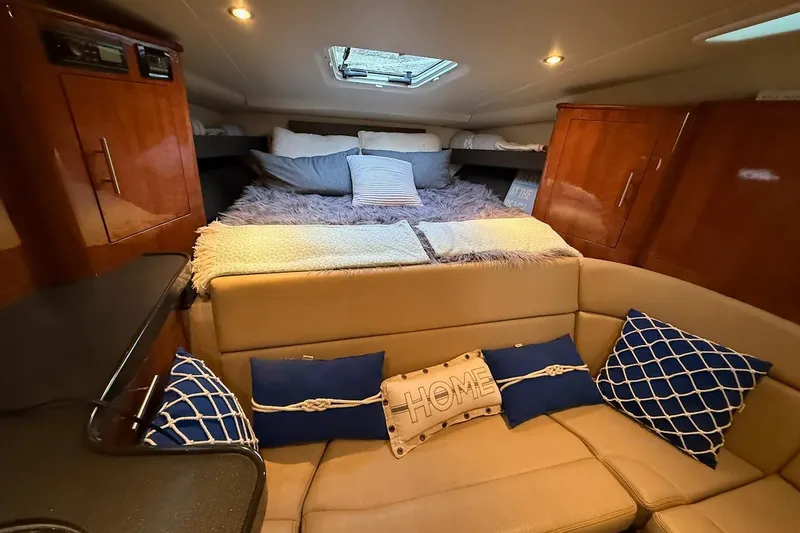 Slide: The Image of Interior of 2012 Regal 35 Sport Coupe with cozy seating and decorative pillows. - 16