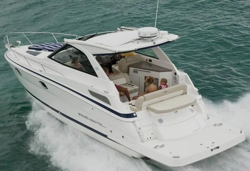 Slide: The Image of Manufacturer Provided Image: 2012 Regal 35 Sport Coupe cruising on the water with passengers onboard. - 2
