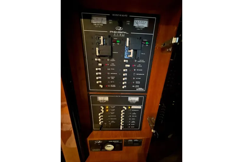 Slide: The Image of Control panel of a 2012 Regal 35 Sport Coupe boat, featuring various switches and indicators. - 27