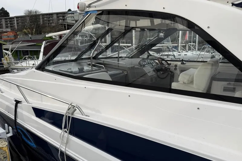 Slide: The Image of 2012 Regal 35 Sport Coupe yacht docked at marina, showcasing sleek design and luxurious interior. - 3