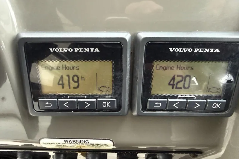 Slide: The Image of Volvo Penta engine hour meters showing 419 and 420 hours on a 2012 Regal 35 Sport Coupe. - 30