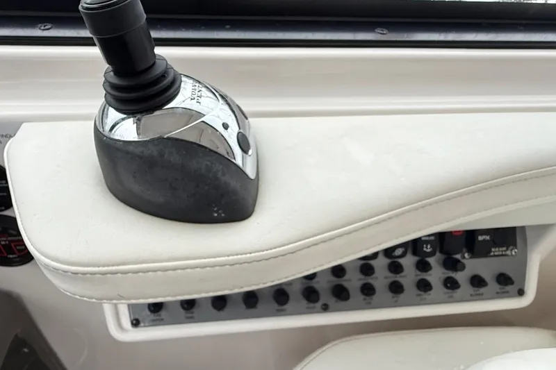 Slide: The Image of Control panel of a 2012 Regal 35 Sport Coupe boat with joystick and switches. - 34