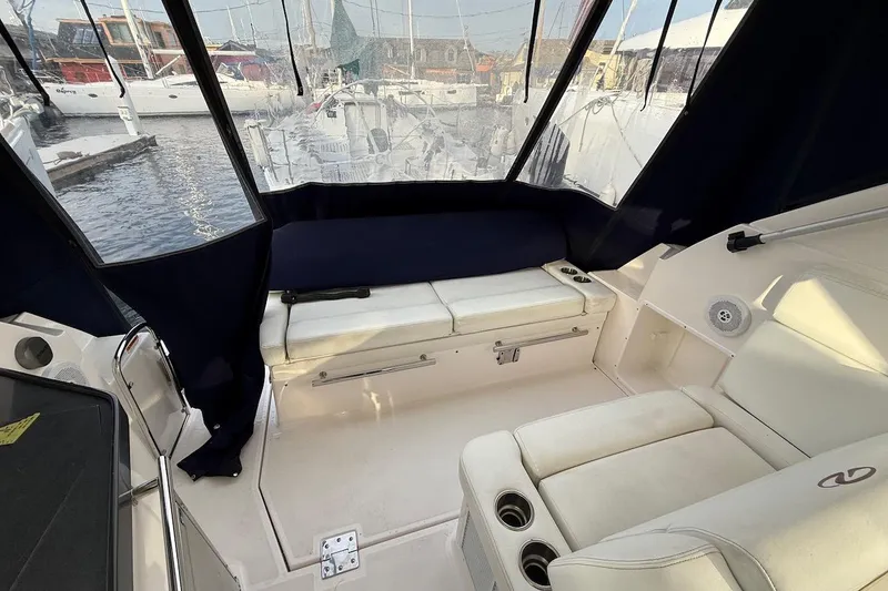 Slide: The Image of 2012 Regal 35 Sport Coupe interior with white seating and marina view. - 6
