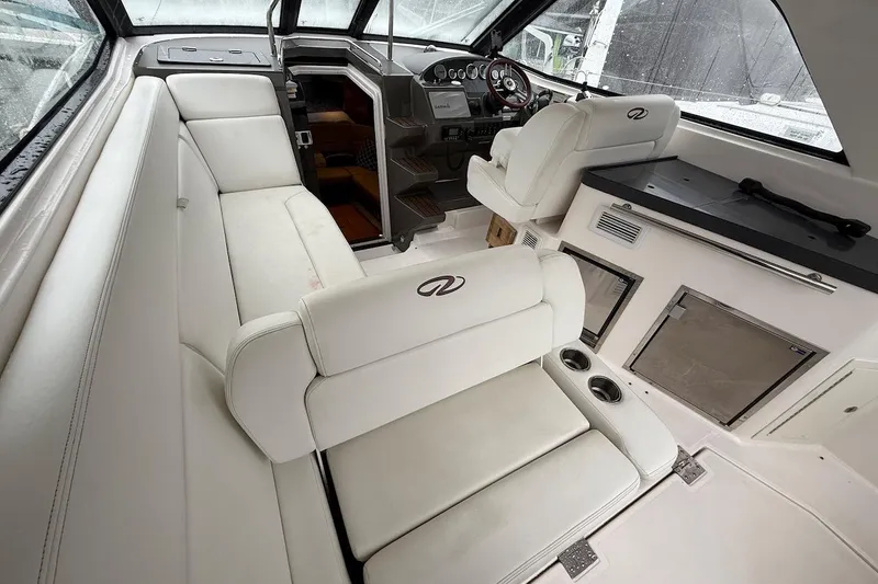 Slide: The Image of Interior of 2012 Regal 35 Sport Coupe with white seating and modern dashboard. - 9
