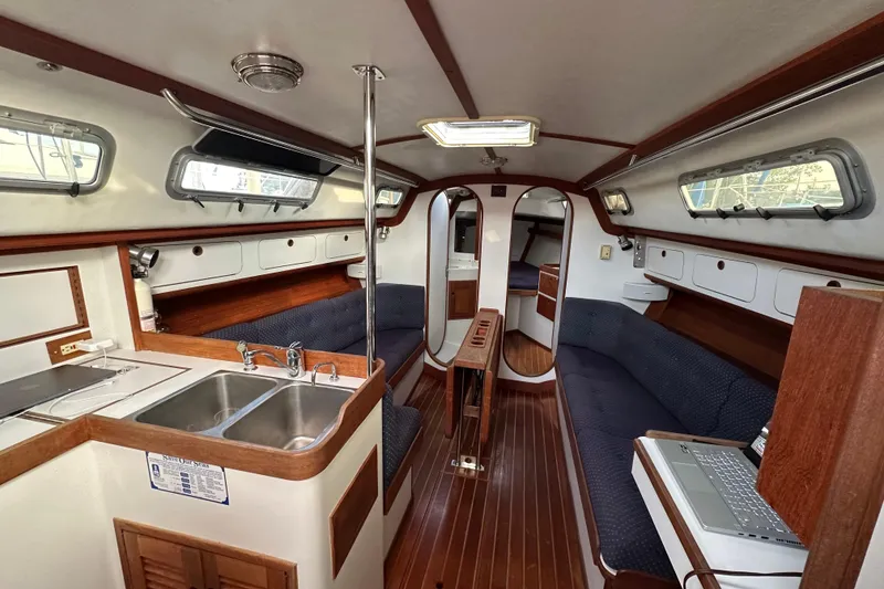 Slide: The Image of Interior of a 1992 J Boats J/35 sailboat with wood accents and cozy seating. - 10