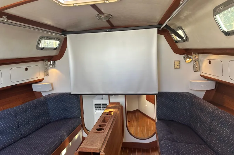 Slide: The Image of Interior of a 1992 J Boats J/35 sailboat with cozy seating and wooden accents. - 11