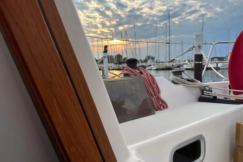 Slide: The Image of 1992 J Boats J/35 sailboat at marina during sunset, with ropes and wooden details. - 13