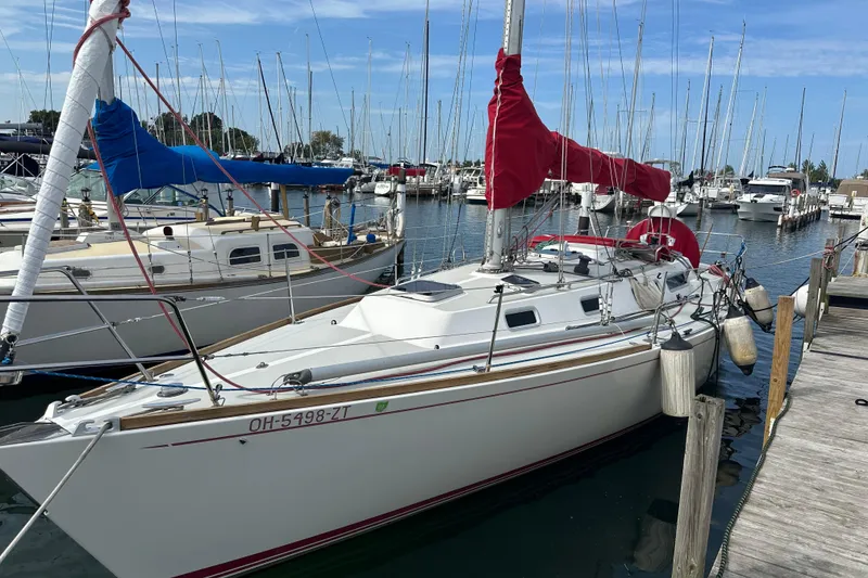 Slide: The Image of 1992 J Boats J/35 sailboat docked in marina with red sail covers. - 4