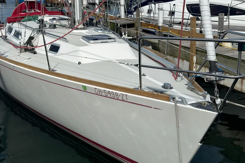 Slide: The Image of 1992 J Boats J/35 sailboat docked in marina, featuring sleek design and white hull. - 5
