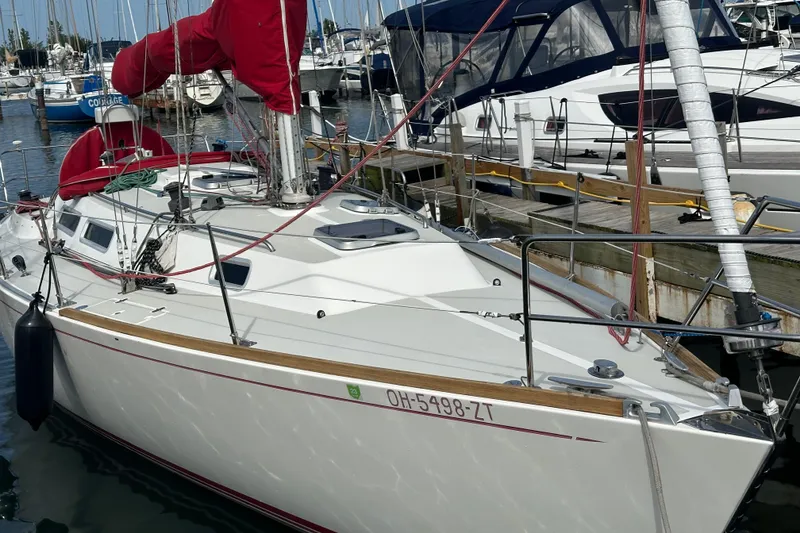 Slide: The Image of 1992 J Boats J/35 sailboat docked in marina with red sail covers. - 6